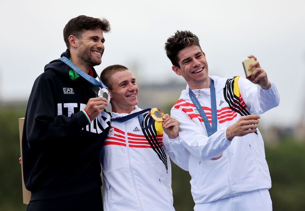 PARIS FRANCE JULY 27 Gold medalist Remco Evenepoel of Team BelgiumC Silver medalist Filippo Ganna of Team Italy L and Bronze medalist Wout van Aert of Team Belgium R pose and take a selfie on the podium at the Pont Alexandre III during the Mens Individual Time Trial on day one of the Olympic Games Paris 2024 at Pont Alexandre III on July 27 2024 in Paris France Photo by Tim de WaeleGetty Images