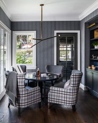 Grey dining room with tartan upholstered armchairs