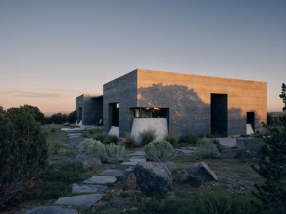 views of Sombra de Santa Fe, new mexico house, with dark, minimalist geometric volumes and clean walls and long nature views