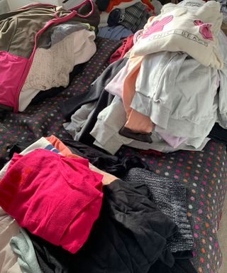 Clothes spread out over a bed