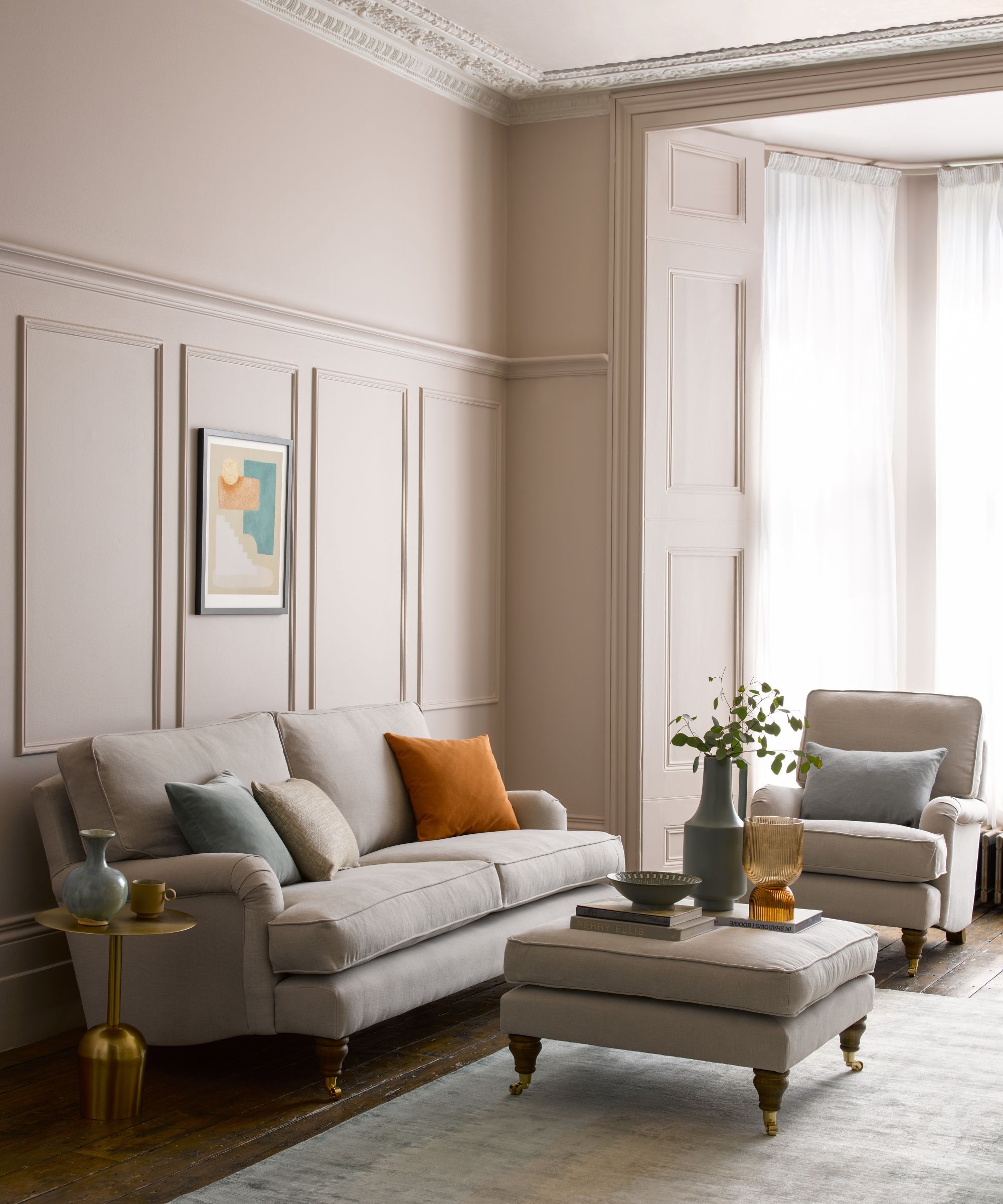 Neutral living room with footstool in foreground
