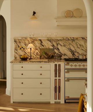 neptune neutral kitchen with shaker style cabinets and marble countertop and backsplash