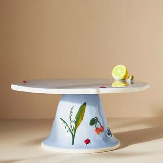 A blue cake stand with painted details