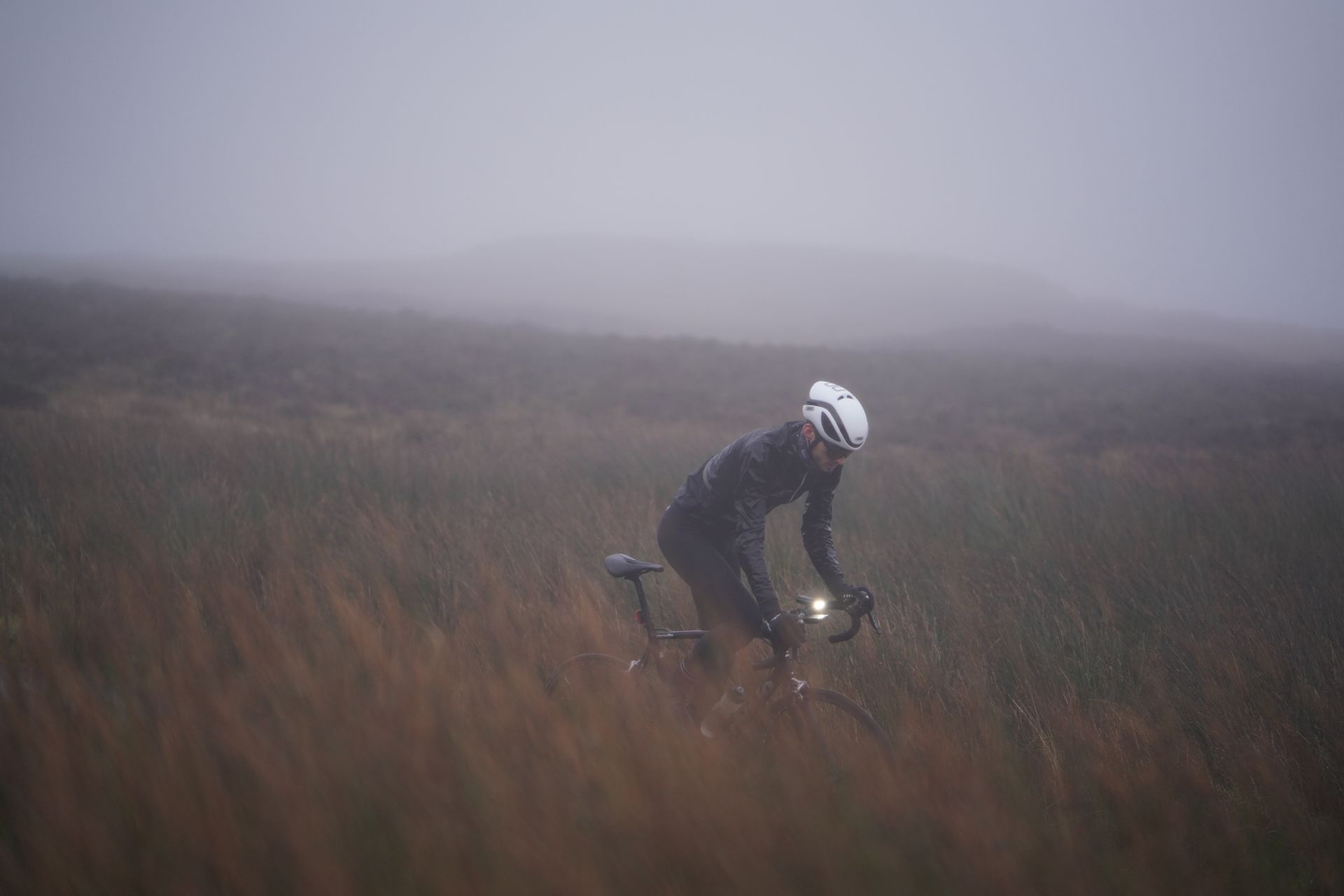 Image shows a person cycling in winter