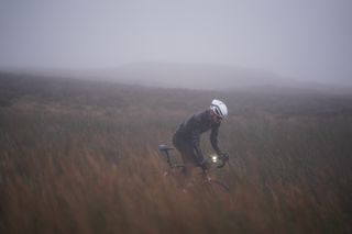 Image shows a person cycling in winter