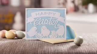 Best Cricut Easter ideas; an Easter card on a wooden table
