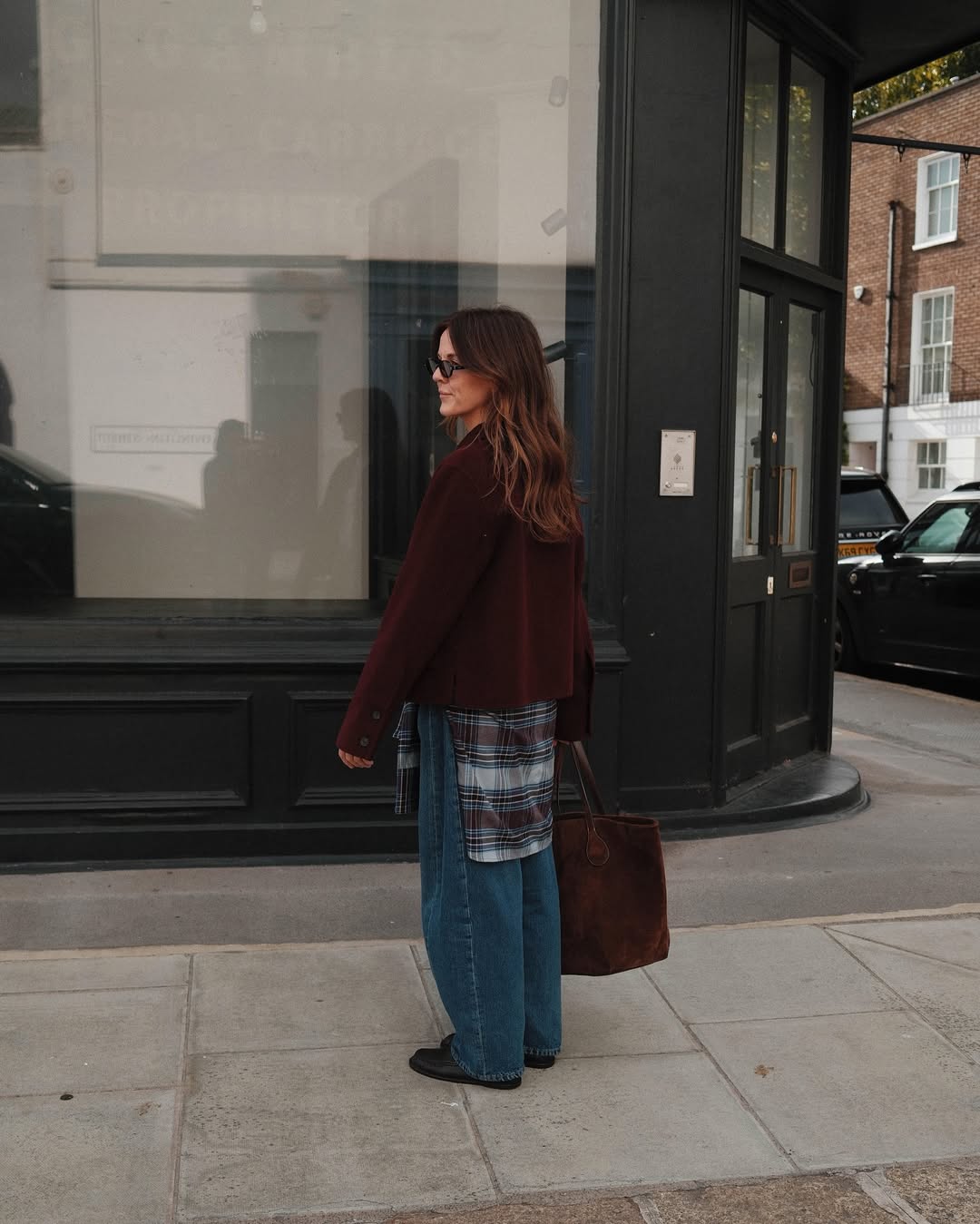 @kimturkington_ wears jeans, flannel shirt and brown blazer