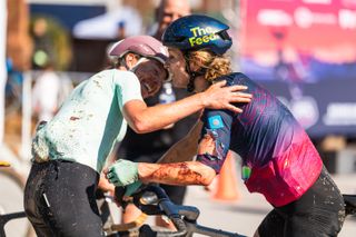 2026 winner Emily Newsom (left) gets a hug from defending champion Lauren De Crescenzo (right), who finished runner-up after struggling with injuries suffered in collision with barbed wire fence 