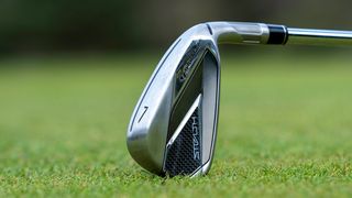 TaylorMade Stealth Iron resting on the turf
