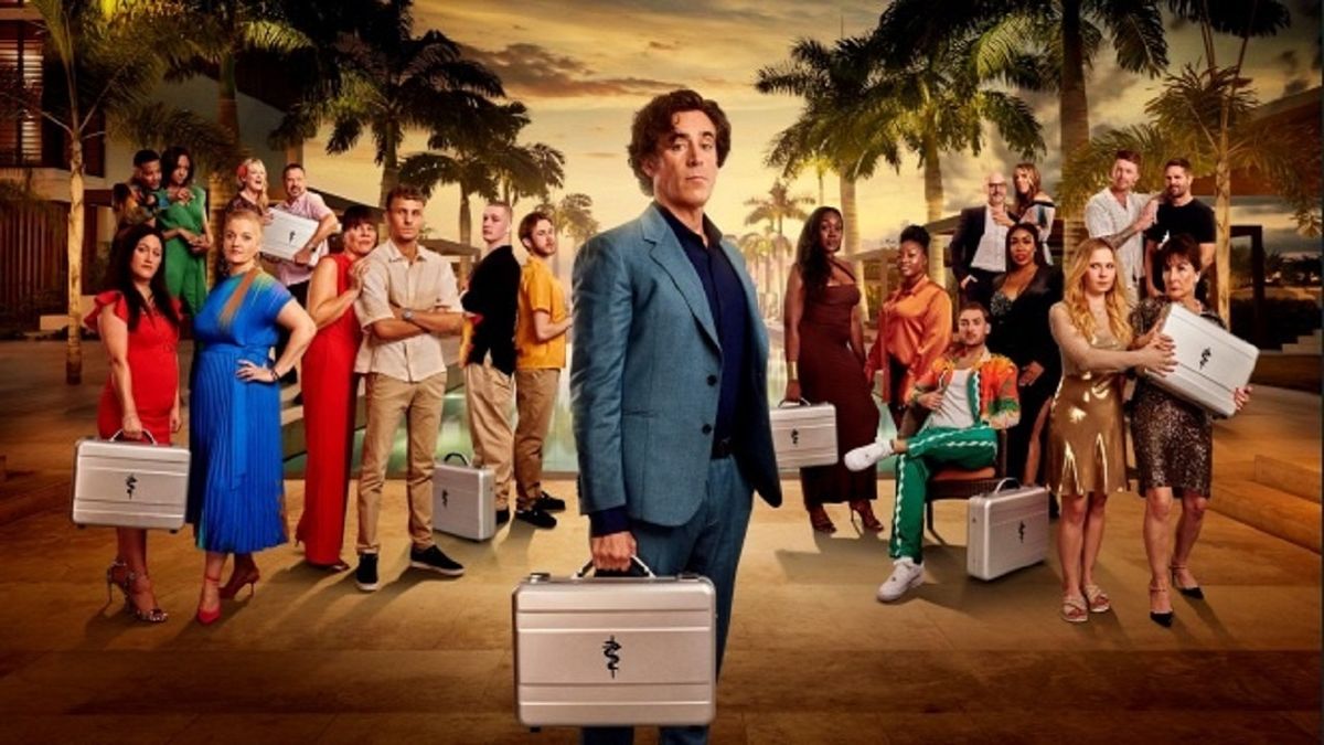 Stephan Mangan holding a silver case in front of the wary-looking contestants of new game show The Fortune Hotel