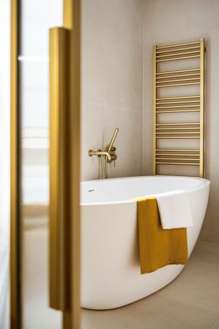 gold fixtures in white bathroom