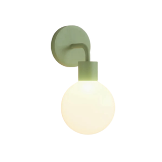 orb light sconce with green hardware