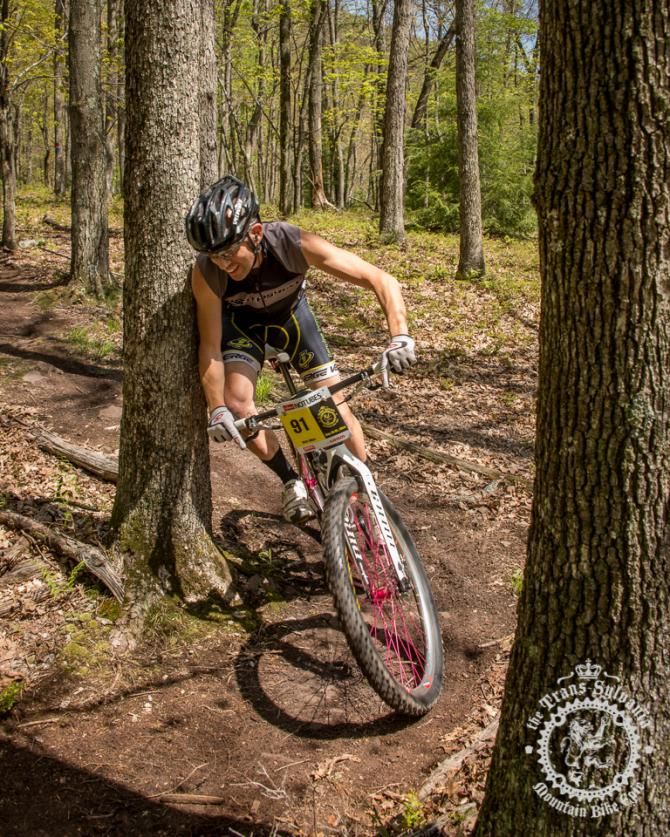 Rich Dillen rubbing by a tree as he races in the singlespeed field