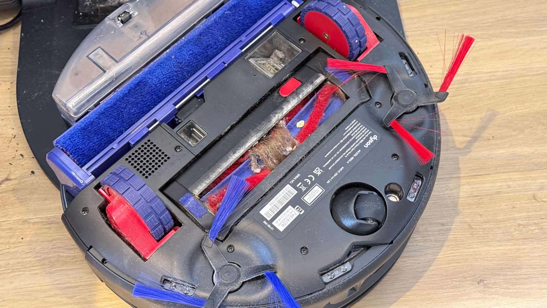 Dyson Spot+Scrub Ai with hair tangled around the roller