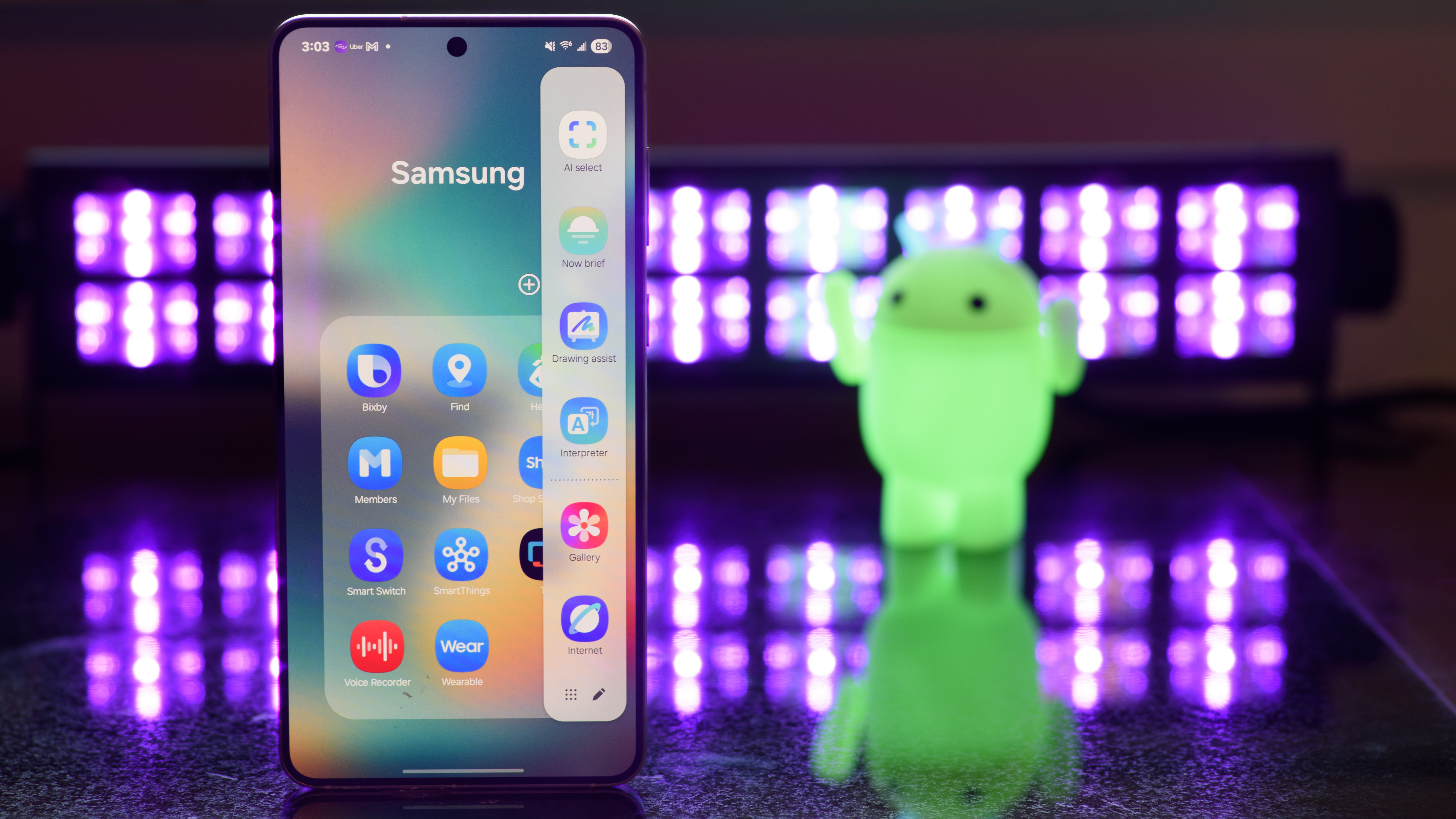 Samsung Galaxy S25 Edge showing the Samsung Edge Panel with black lights and an Android figurine blurred in the background