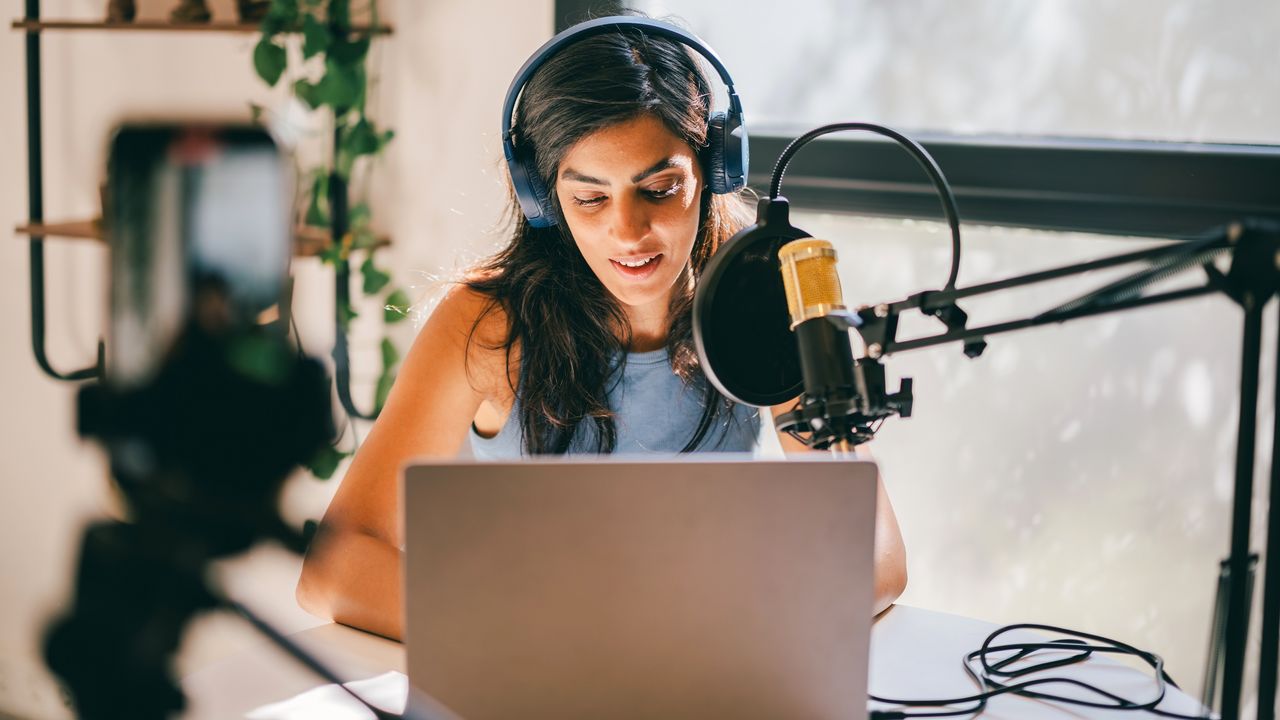 A young woman is set up to do a podcast.