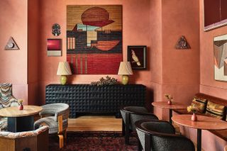 The warmly welcoming interiors of a LA hotel features wood and leather furniture paired with artworks.