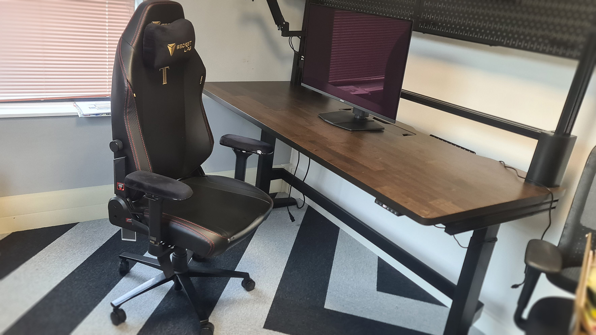 The Secretlab Titan Evo next to a desk in the PC Gamer office.