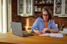 Woman focusing on organizing personal finances learning about Individual savings account (ISA)