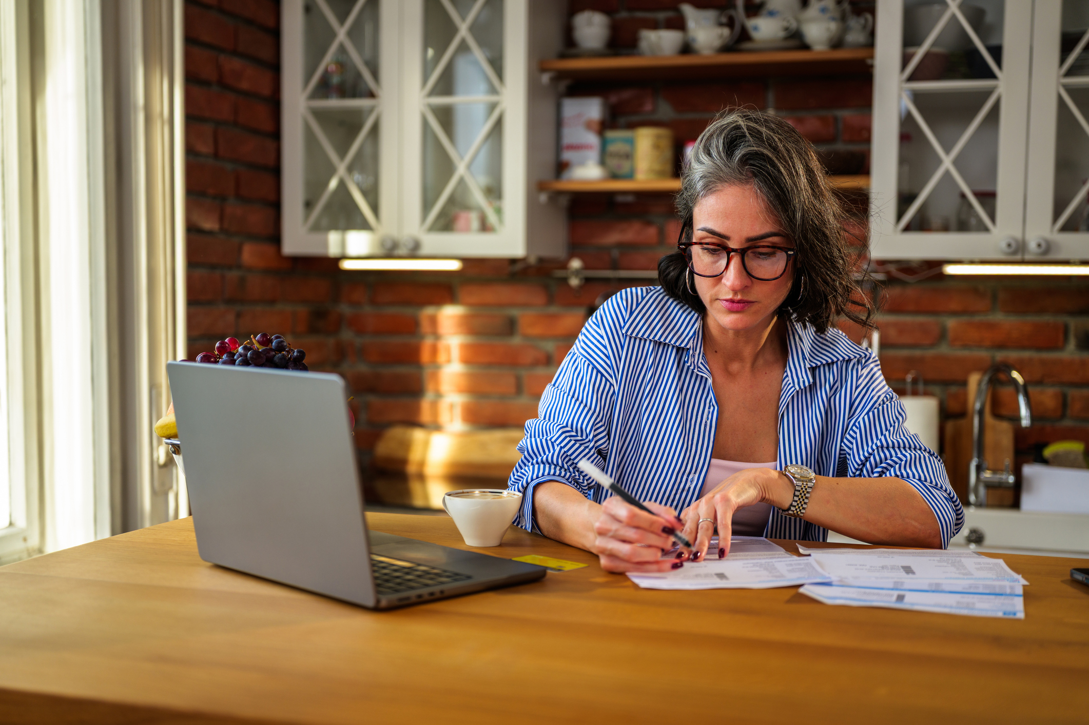 Woman focusing on organizing personal finances learning about Individual savings account (ISA)