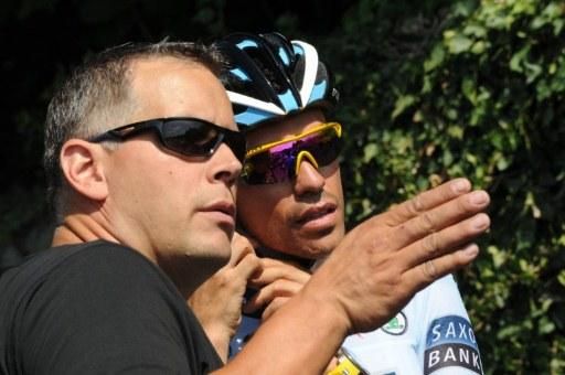 It's that way to Paris; Alberto contador listens on to one of the team directors before a training ride in Murat.