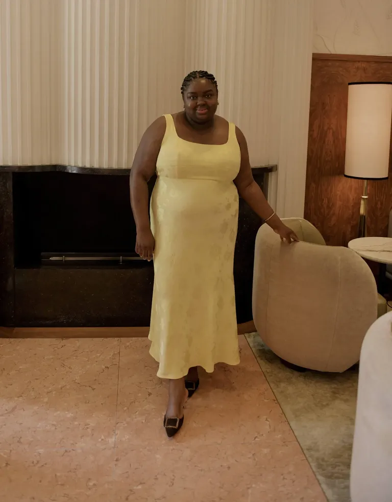 Woman in butter yellow dress.