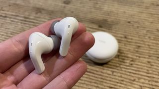 LG Tone Free T90Q earbuds close-up, showing their small design