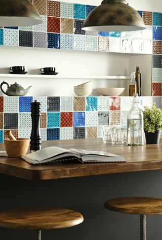 Colourful, patchwork kitchen tiles as a backsplash in a kitchen with wood countertops
