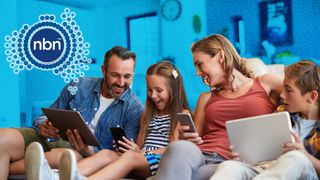 Family sitting on sofa, all using connected devices