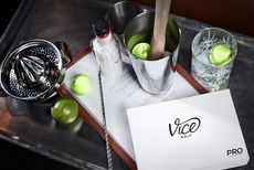 A selection of Vice Golf golf balls in cocktail mixing cups on top of a drinks cart