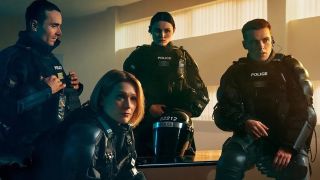 The rookie cast of Blue Lights season 3 gathered in an office in full tactical gear