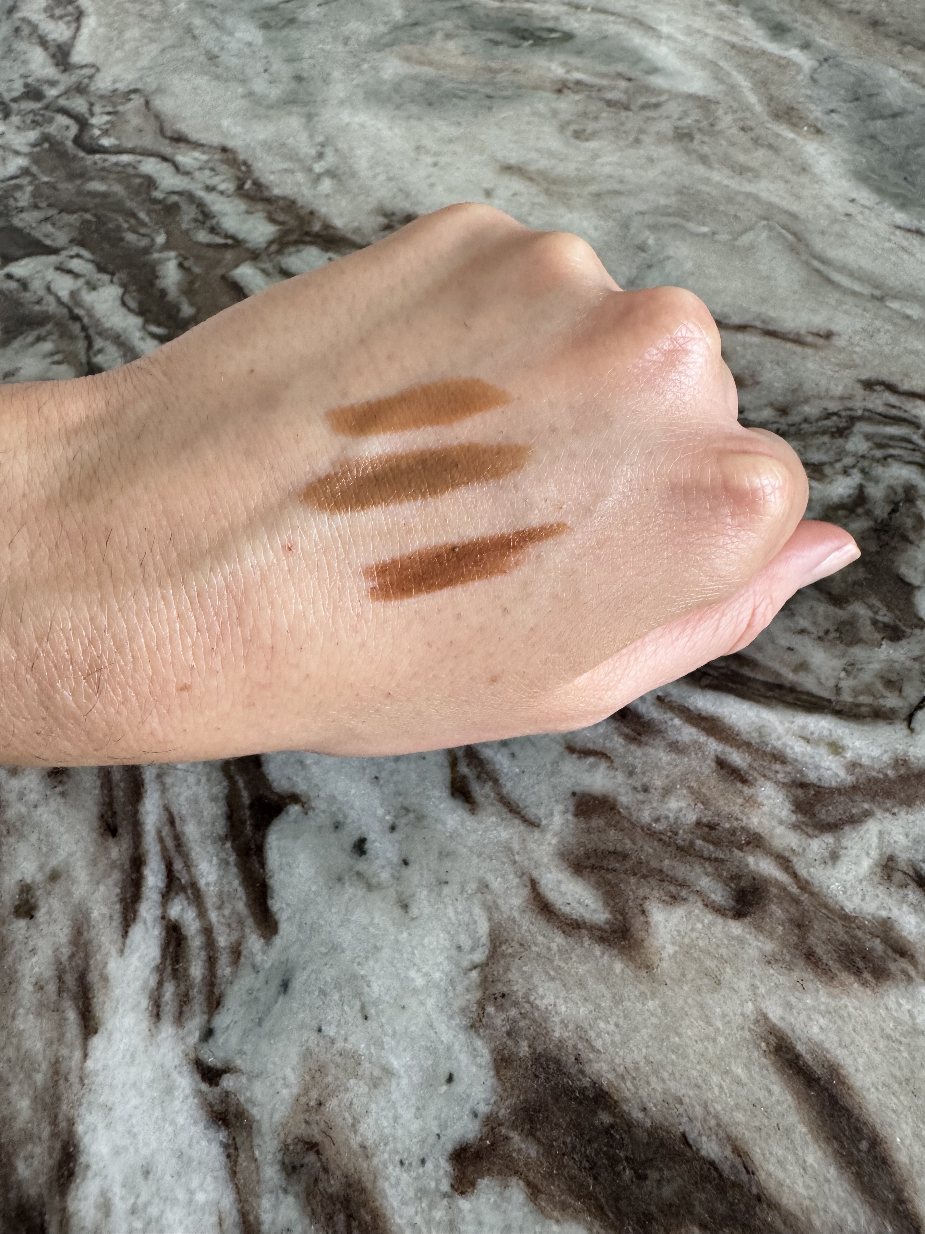 Swatches of the Rhode Pocket Bronze, including Sip, Sunbed and Bake