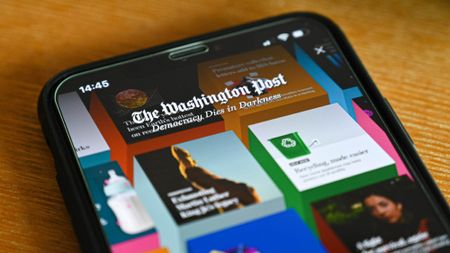 A Washington Post logo is displayed on a smartphone device