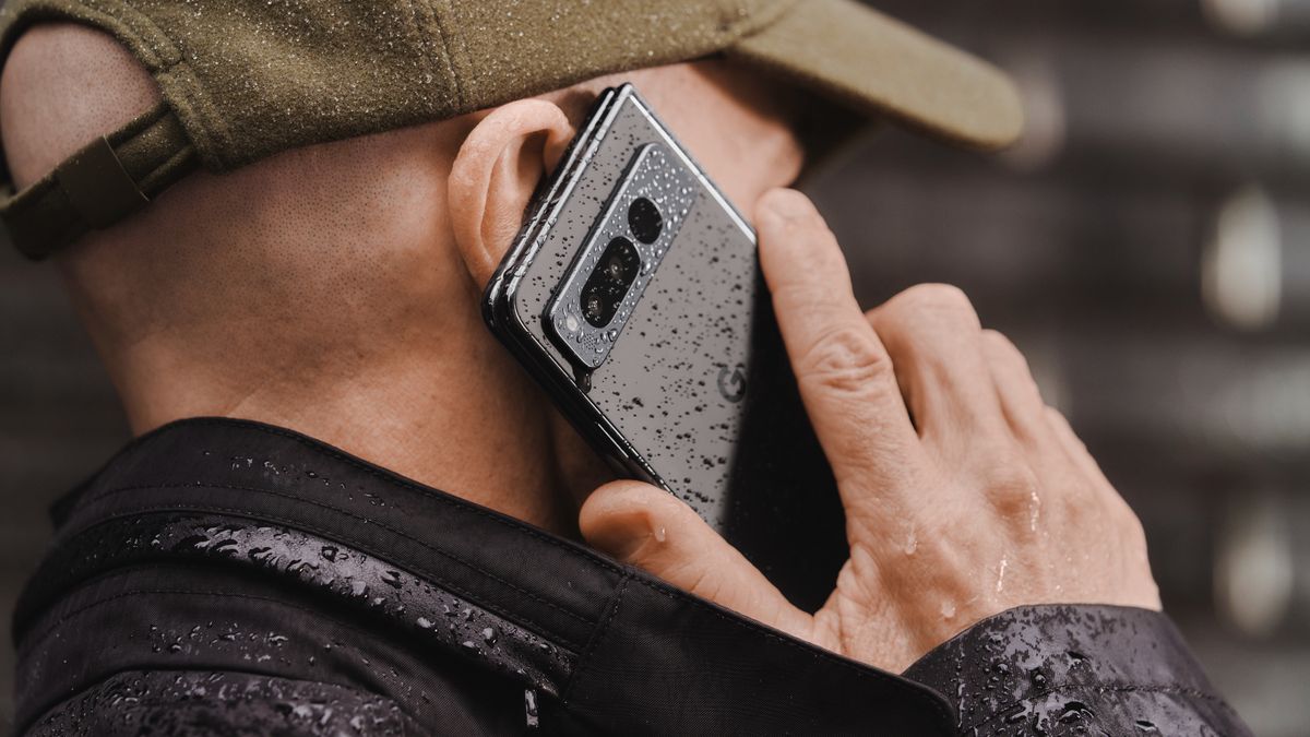 man holding Google Pixel Fold to his ear