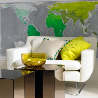 room with white sofa and world map wallpaper
