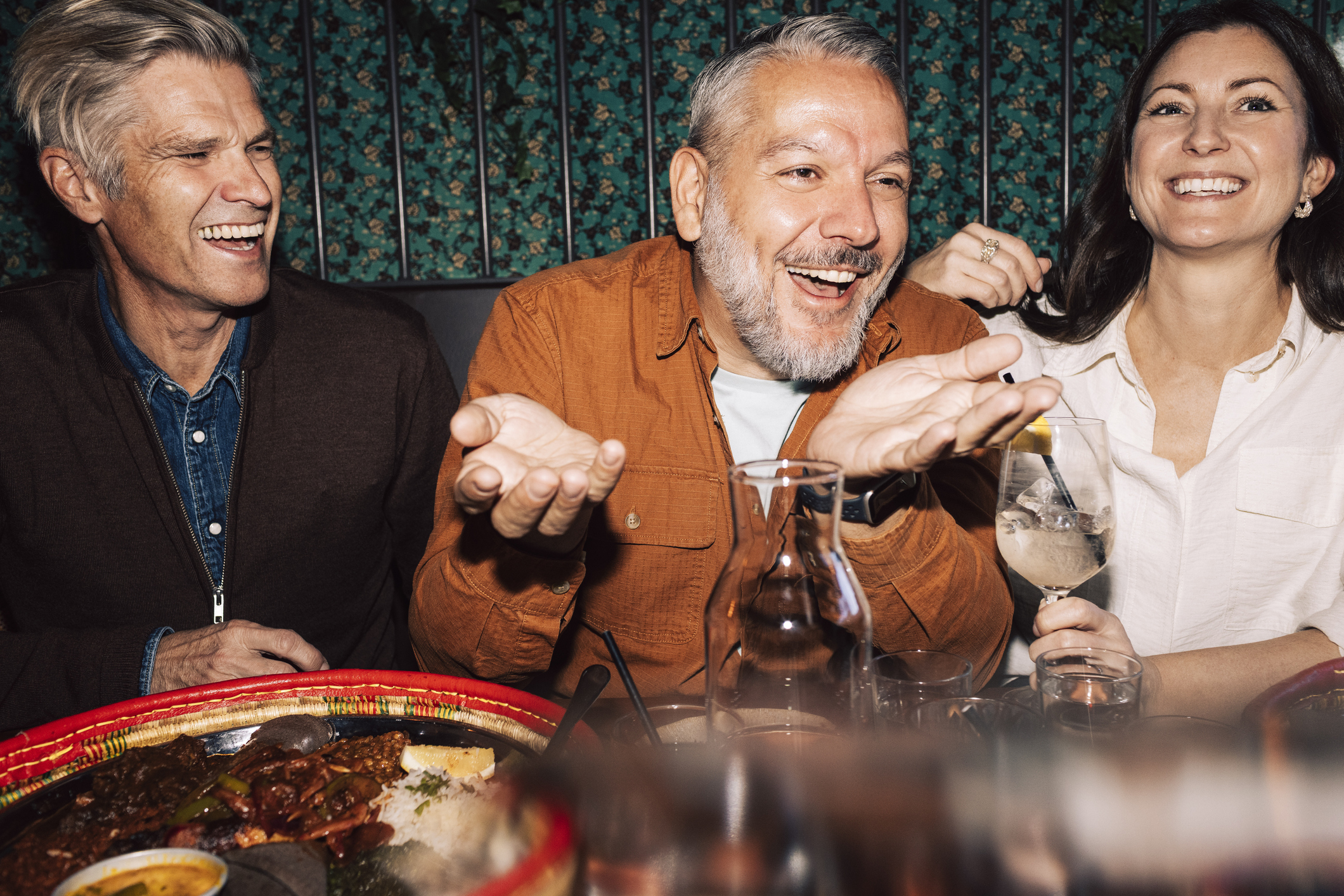 Older friends at a bar