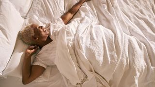 Pink noise for sleep - woman waking up in bed with white duvet
