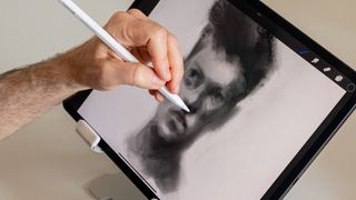 Procreate custom brush advice from Kyle T Webster; a man draws on an iPad