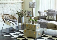 metal trunks with accent chair and sofa with cushions