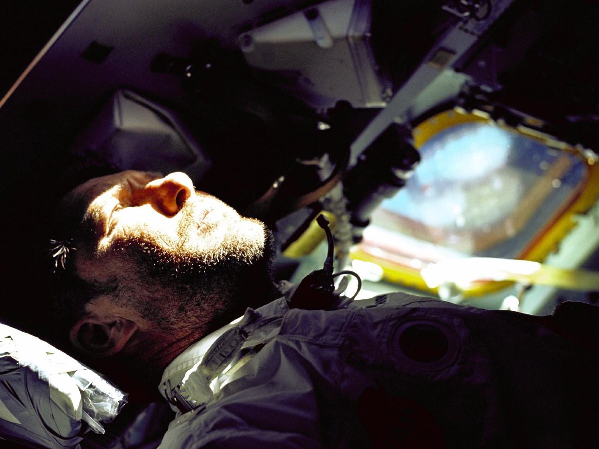 A bearded Walter Schirra, Apollo 7 commander, gazes out the rendezvous window in front of the commander's station on the ninth day of the Earth orbital mission. Apollo 7 was crewed by Donn Eisele and Walter Cunningham. The mission was an engineering test flight designed primarily to test space vehicle and mission support facilities performance during a manned mission.