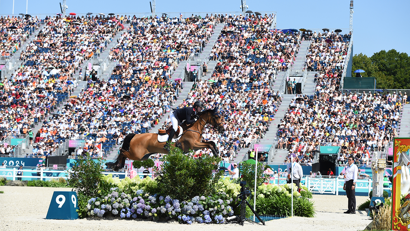 Harry Charles and Romeo 88 clear the open water at the Paris Olympic Games in front of packed stands.