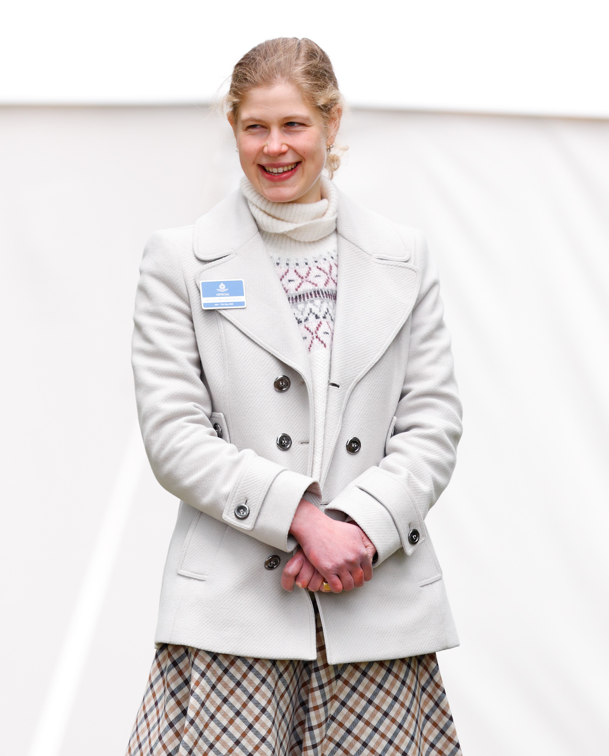 Lady Louise wearing a white coat and smiling