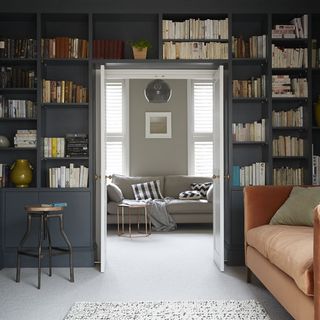 reading room with grey wall book shelves on wall and white floor
