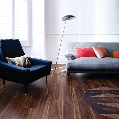 wooden flooring and sofa with white wall