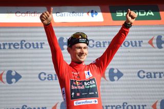 Winner of the stage Team Bora's Primoz Roglic celebrates on the podium wearing the overall leader red jersey during the stage 19 of the Vuelta a Espana, a 173,5 km race between Logrono and Alto de Moncalvillo, on September 6, 2024. (Photo by ANDER GILLENEA / AFP)