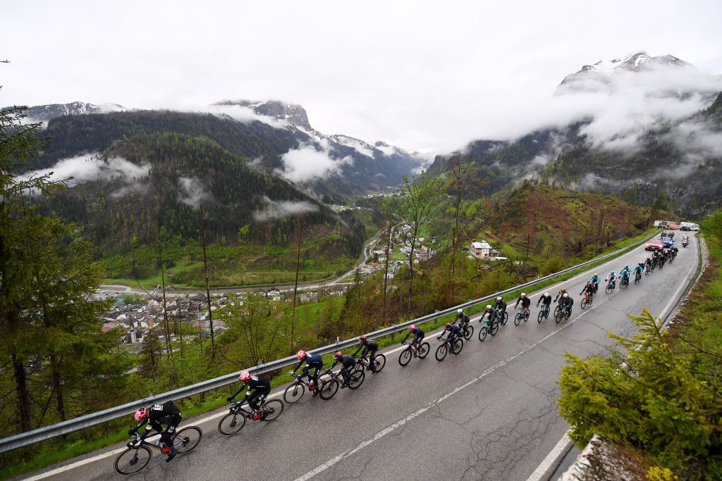 CORTINA DAMPEZZO ITALY MAY 24 Alberto Bettiol of Italy and Team EF Education Nippo Hugh Carthy of United Kingdom and Team EF Education Nippo Egan Arley Bernal Gomez of Colombia and Team INEOS Grenadiers Pink Leader Jersey leads the peloton passing through Colle Santa Lucia 1435m mountain landscape during the 104th Giro dItalia 2021 Stage 16 a 153km stage shortened due to bad weather conditions from Sacile to Cortina dAmpezzo 1210m Rain Fog Snow girodiitalia Giro on May 24 2021 in Cortina dAmpezzo Italy Photo by Tim de WaeleGetty Images