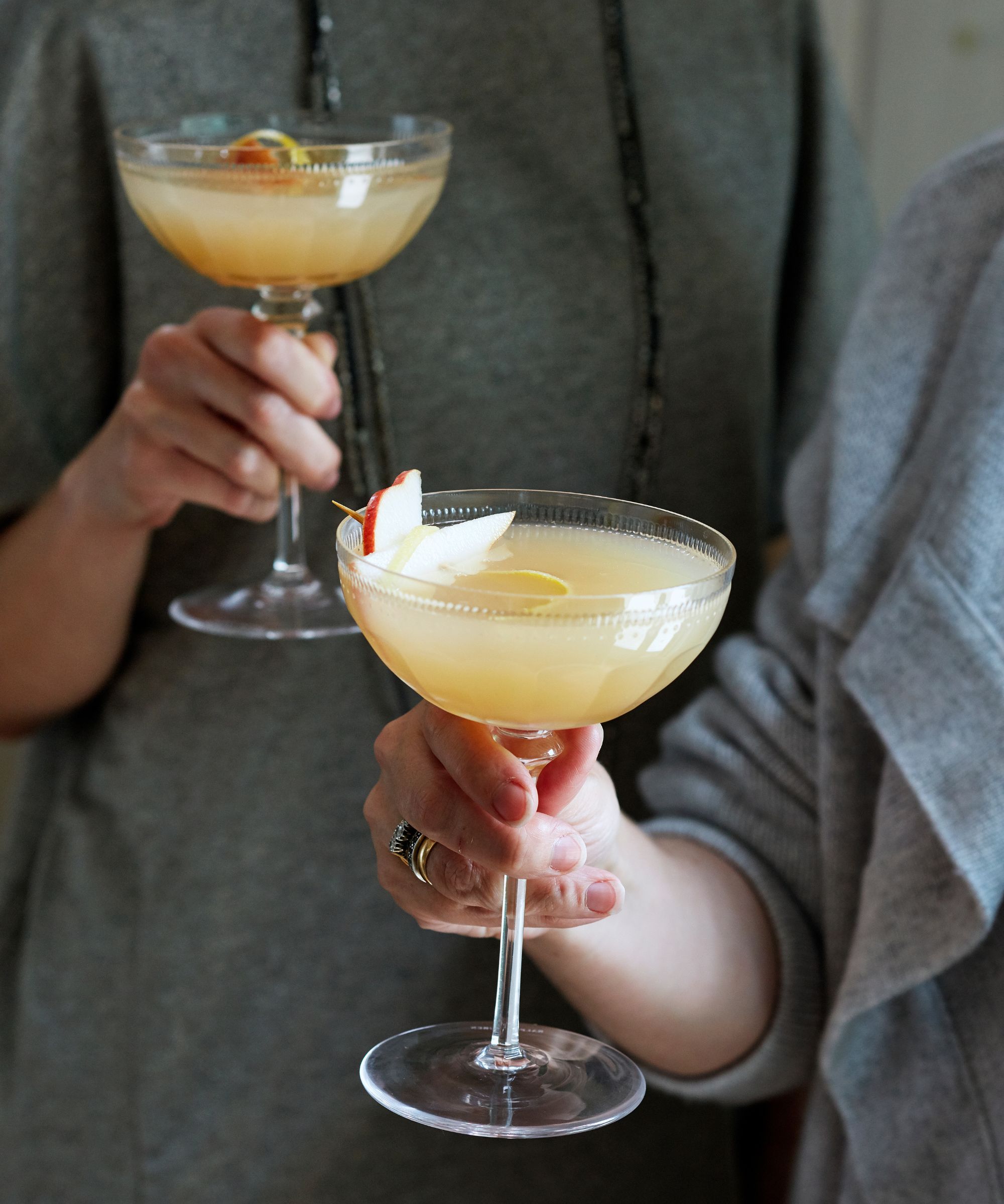 hands holding cocktails