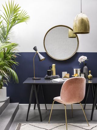home office with white and blue colour blocking on walls and desk with large round mirror by pooky