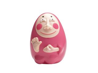 Pink egg-shaped ceramic object with a face and 2 hands
