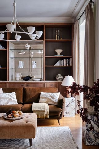 living room with rust sofa and cushions